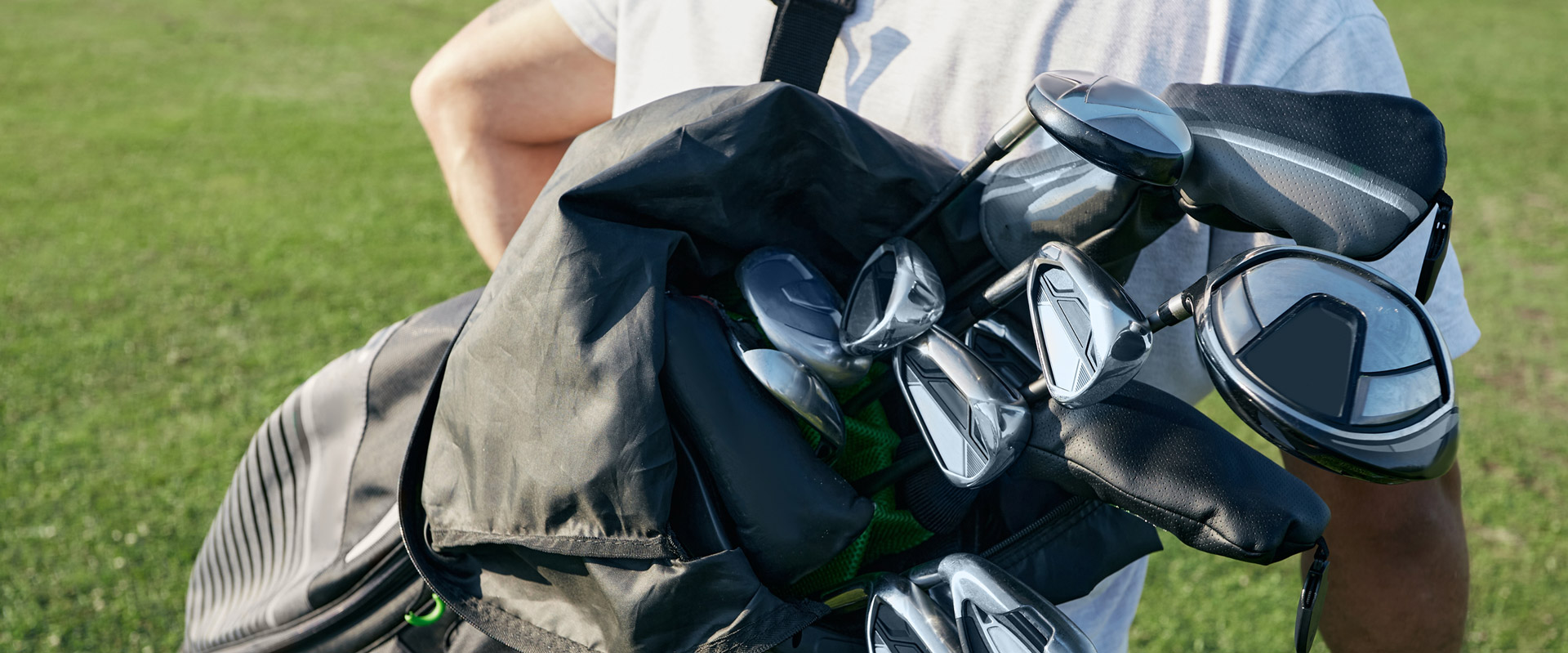 Golfer carrying bag